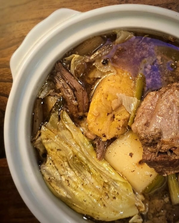 A top-down view of a bowl of Filipino stew called nilaga.