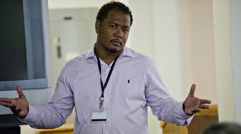 Omar Howard (shown in 2014) speaks with residents of the Atlanta Transitional Center. Howard, once an inmate in a correctional facility himself, is now a chaplain and motivational speaker. JONATHAN PHILLIPS / SPECIAL