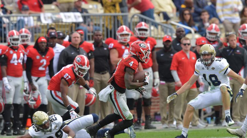 November 25, 2017 Atlanta - Georgia returner Mecole Hardman (4) eludes Georgia Tech defensive back Tariq Carpenter (29) in the second half of an NCAA college football game at Bobby Dodd Stadium on Saturday, November 25, 2017. Georgia defeat Georgia Tech 38-7. HYOSUB SHIN / HSHIN@AJC.COM