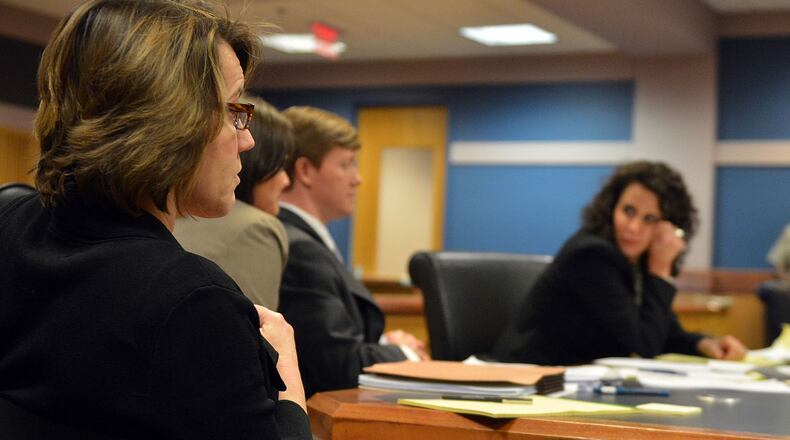Stacey Kalberman (left) listens to arguments as Judge Ural Glanville presides over Kalberman's whistleblower lawsuit in Fulton County Superior Court Monday, March 31, 2014.