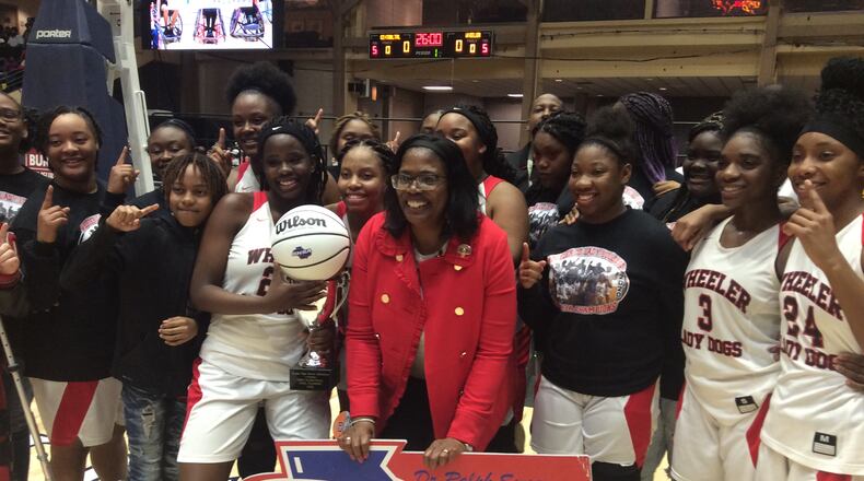 Coach Angelia Wright and the Wheeler County players celebrate the first girls basketball championship in school history on March 4, 2020, at the Macon Centreplex.