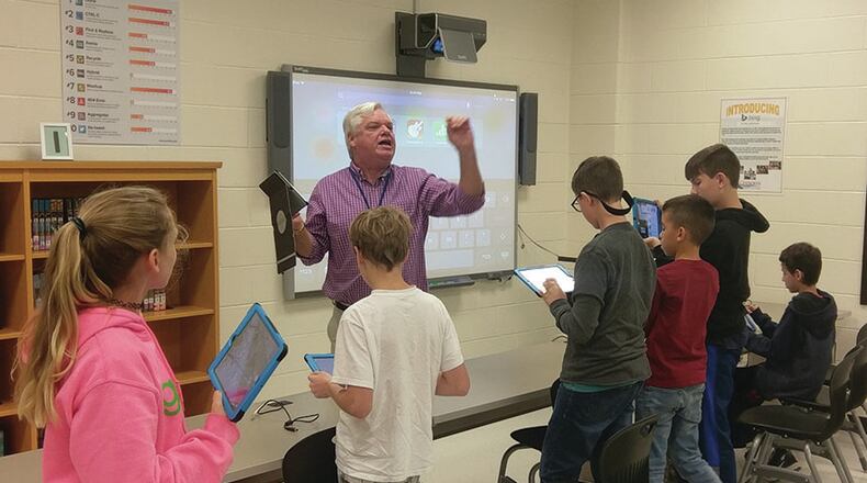 Cherokee County School District instructional technology specialist Jim Berry leads a lesson in the media center.