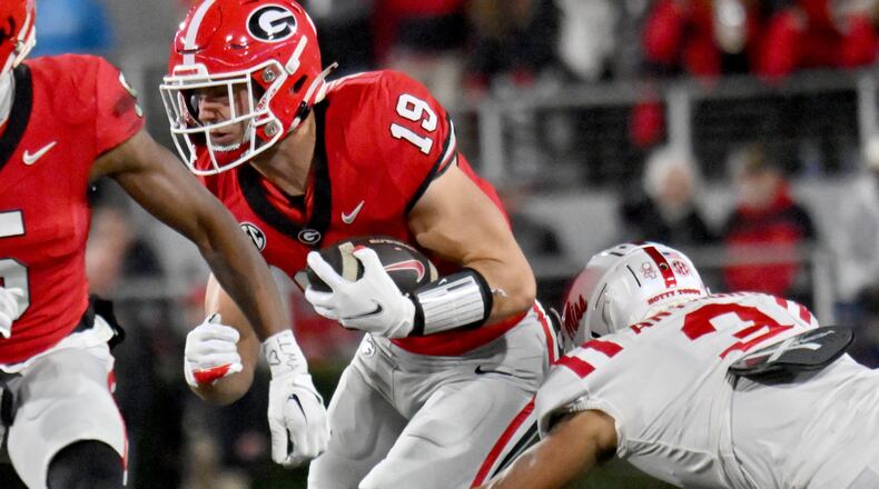 Georgia tight end Brock Bowers (19) runs past Mississippi safety Daijahn Anthony (3) during the first half in an NCAA football game at Sanford Stadium, Saturday, November 11, 2023, in Athens. Georgia won 52-17 over Mississippi. (Hyosub Shin / Hyosub.Shin@ajc.com)