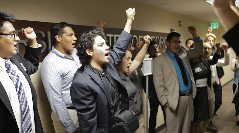 Students protested policies that require Deferred Action for Childhood Arrivals recipients to pay more expensive out-of-state tuition at Georgia’s public colleges during a 2016 state Board of Regents meeting. AJC FILE PHOTO