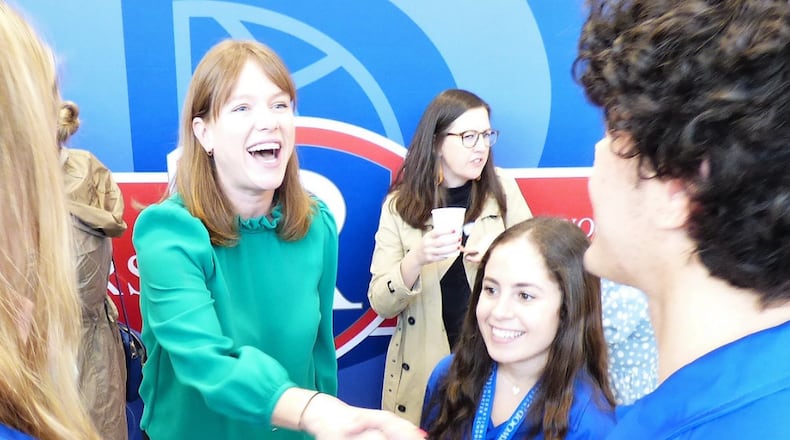 White House Communications Director Kate Bedingfield greeted students and guests after her inauguration into the Distinguished Alumni Program at Riverwood High.