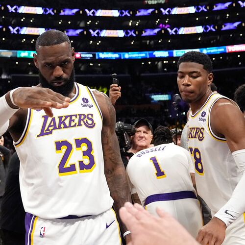 FILE - Los Angeles Lakers forward LeBron James salutes public address announcer Lawrence Tanter prior to an NBA basketball game against the Denver Nuggets Saturday, March 2, 2024, in Los Angeles. (AP Photo/Mark J. Terrill,File)