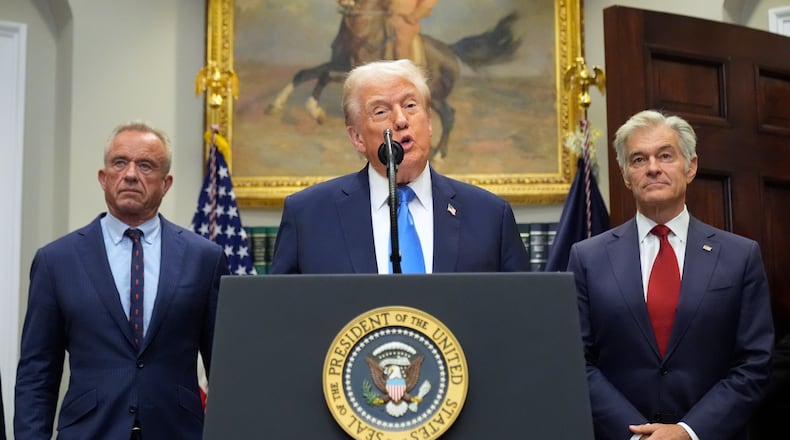 President Donald Trump speaks inside the Roosevelt Room of the White House on Monday, Sept. 22, 2025, in Washington, D.C., as Health and Human Services Secretary Robert F. Kennedy Jr. (left) and Centers for Medicare and Medicaid Services administrator Dr. Mehmet Oz listen. (Mark Schiefelbein/AP)