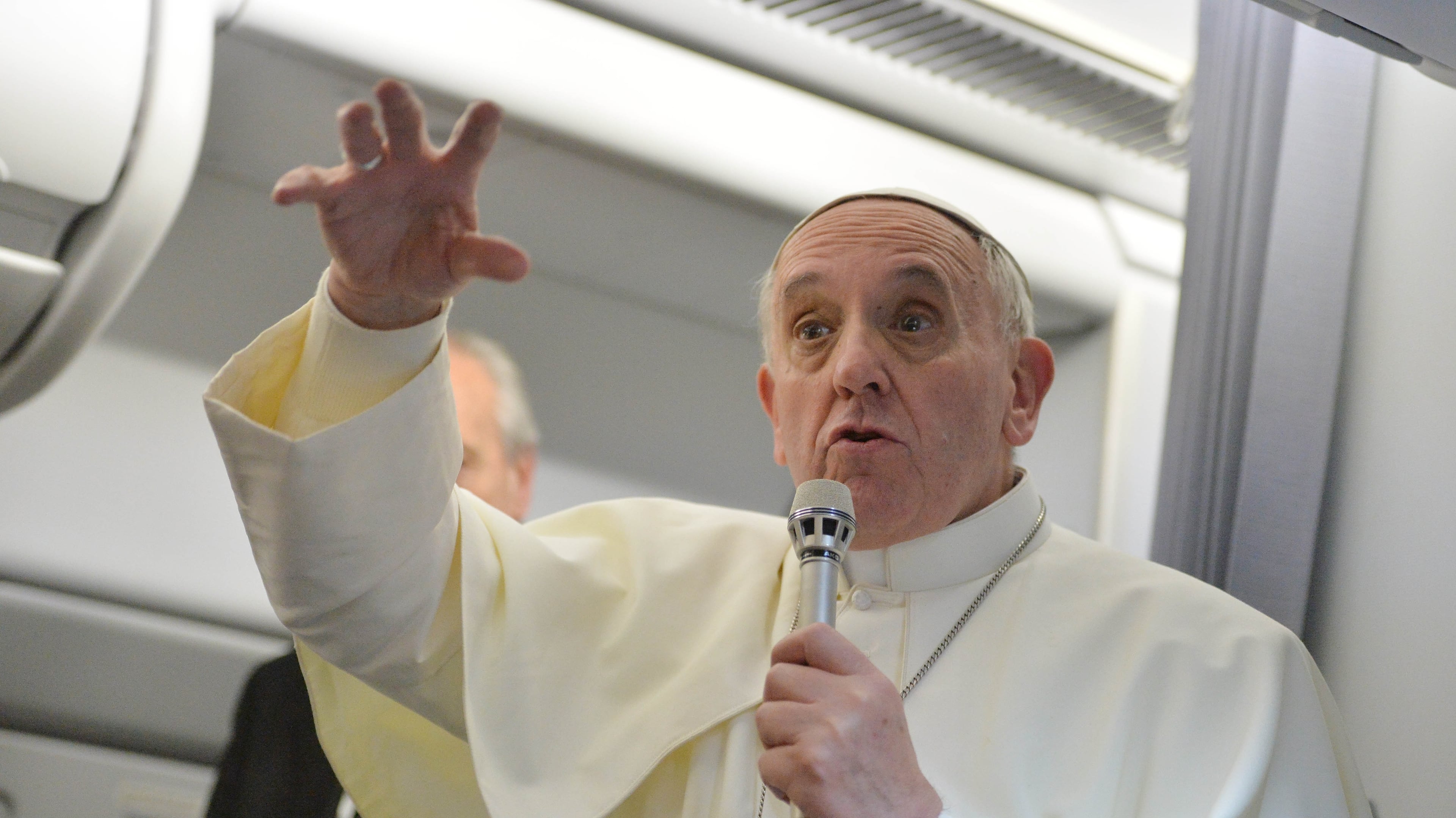 FILE - Pope Francis answers reporters questions during a news conference aboard the papal flight on its way back from Brazil, Monday, July 29, 2013. (AP Photo/Luca Zennaro, Pool, File)
