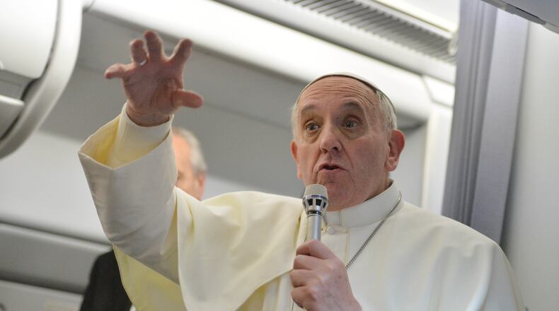 FILE - Pope Francis answers reporters questions during a news conference aboard the papal flight on its way back from Brazil, Monday, July 29, 2013. (AP Photo/Luca Zennaro, Pool, File)