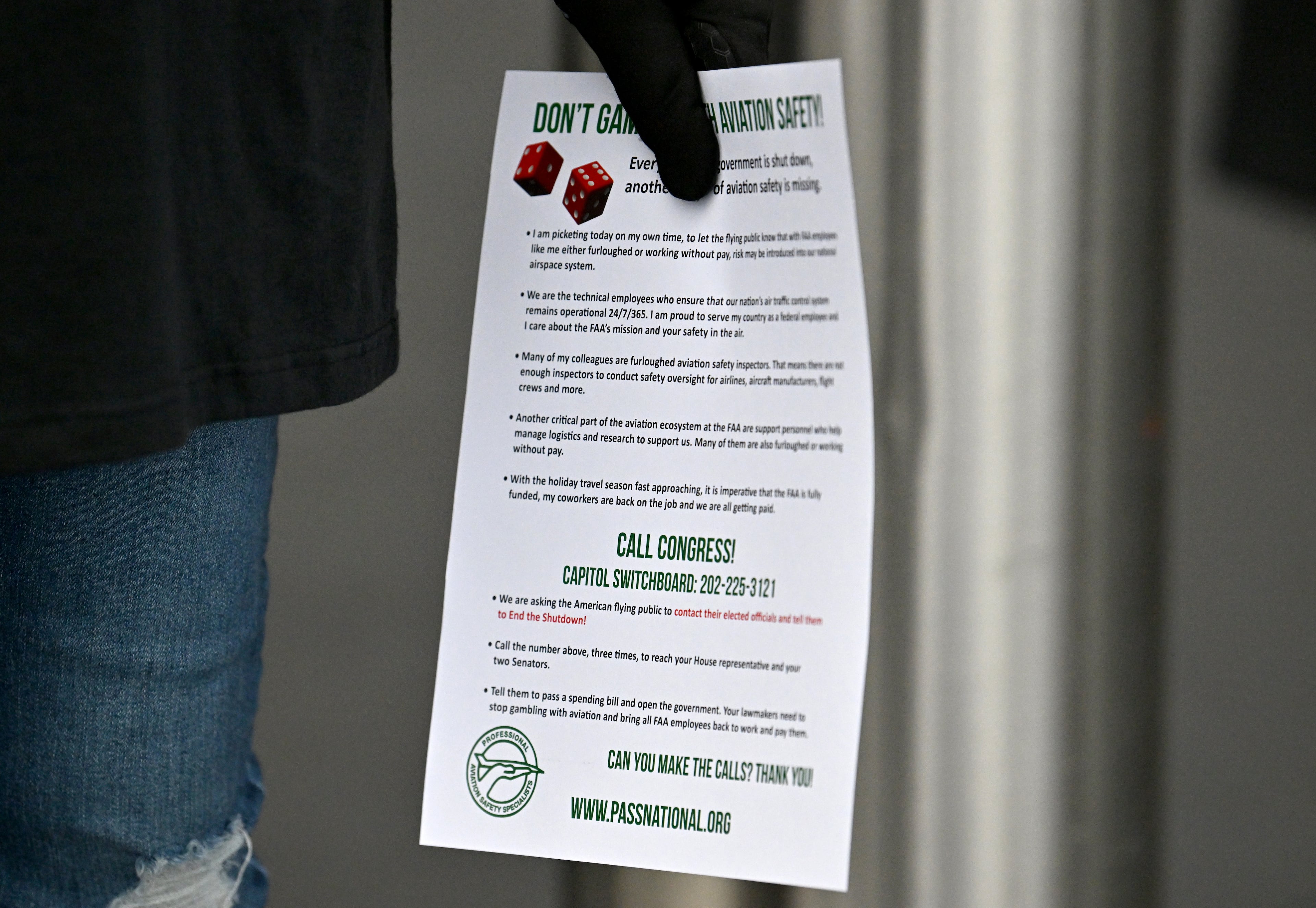 Daphne Hosea, union member of PASS, holds a flyer at Hartsfield-Jackson Atlanta International Airport's domestic terminal, Wednesday, October 29, 2025, in Atlanta. (Hyosub Shin/AJC)