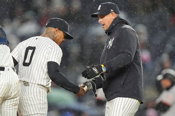 New York Yankees manager Aaron Boone, right, takes the ball from Marcus Stroman (0) as Stroman leaves during the first inning of a baseball game against the San Francisco Giants Friday, April 11, 2025, in New York. (AP Photo/Frank Franklin II)