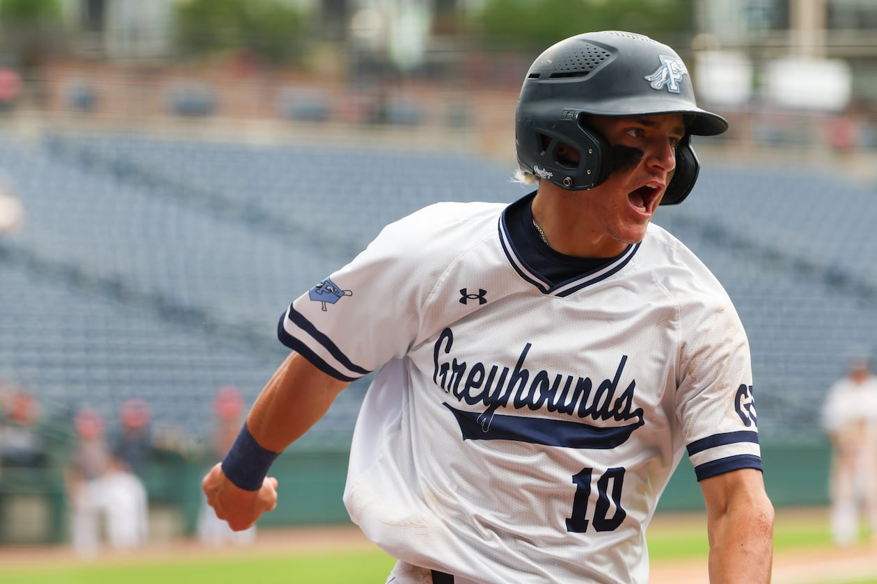 Pope’s Parker Troughton scores in the fourth inning of Game 2 against Loganville in the GHSA Class 5A baseball championship series at Gwinnett Field in Lawrenceville on May 26, 2026. Pope won the game, but ultimately not the series. (Arvin Temkar/AJC)