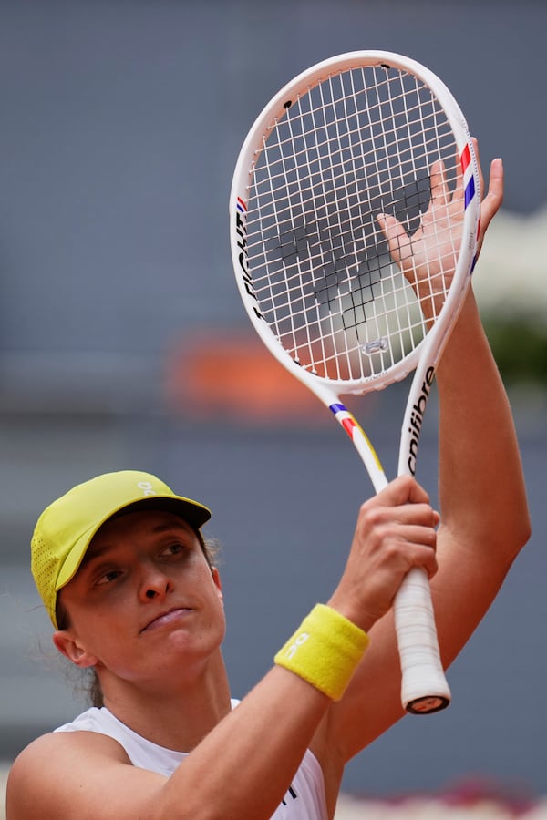 Iga Swiatek of Poland celebrates following her victory over United States' Madison Keys during the Madrid Open tennis tournament in Madrid, Spain, Wednesday, April 30, 2025. (AP Photo/Manu Fernandez)