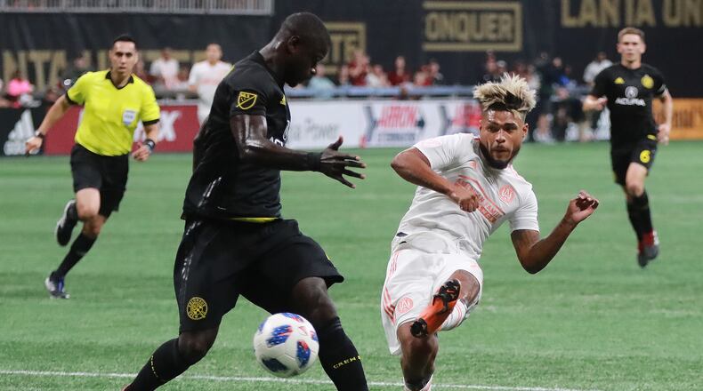 Atlanta United forward Josef Martinez makes the MLS season record tieing goal past Columbus Crew defender Jonathan Mensah for a 1-0 lead during the first half in a MLB soccer match on Sunday, August 19, 2018, in Atlanta.  Curtis Compton/ccompton@ajc.com