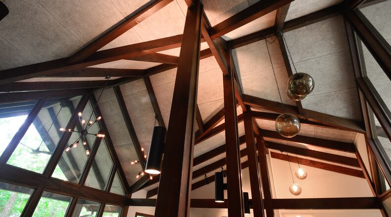 The beams define and separate the living area and dining room in the home's open floor plan.