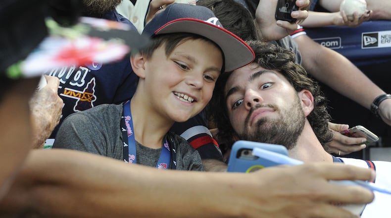 Atlanta Braves shortstop Dansby Swanson poses with 9-year-old fan Caleb Zurawick of Chattanooga, Tenn., before a game against the Philadelphia Phillies on Wednesday, Sept. 28, 2016, in Atlanta. (AP Photo/John Amis)