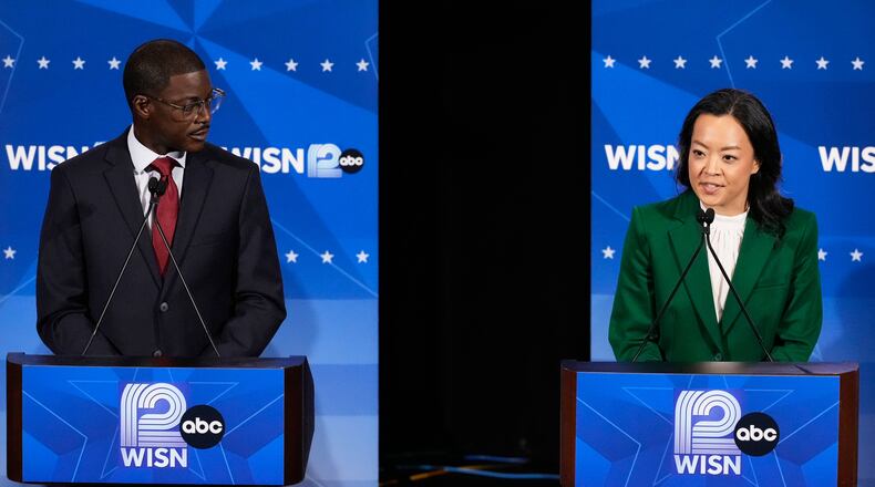 Democratic gubernatorial candidate Francesca Hong, right, talks as David Crowley listens during a primary debate in Milwaukee, Tuesday, July 28, 2026. (AP Photo/Nam Y. Huh)