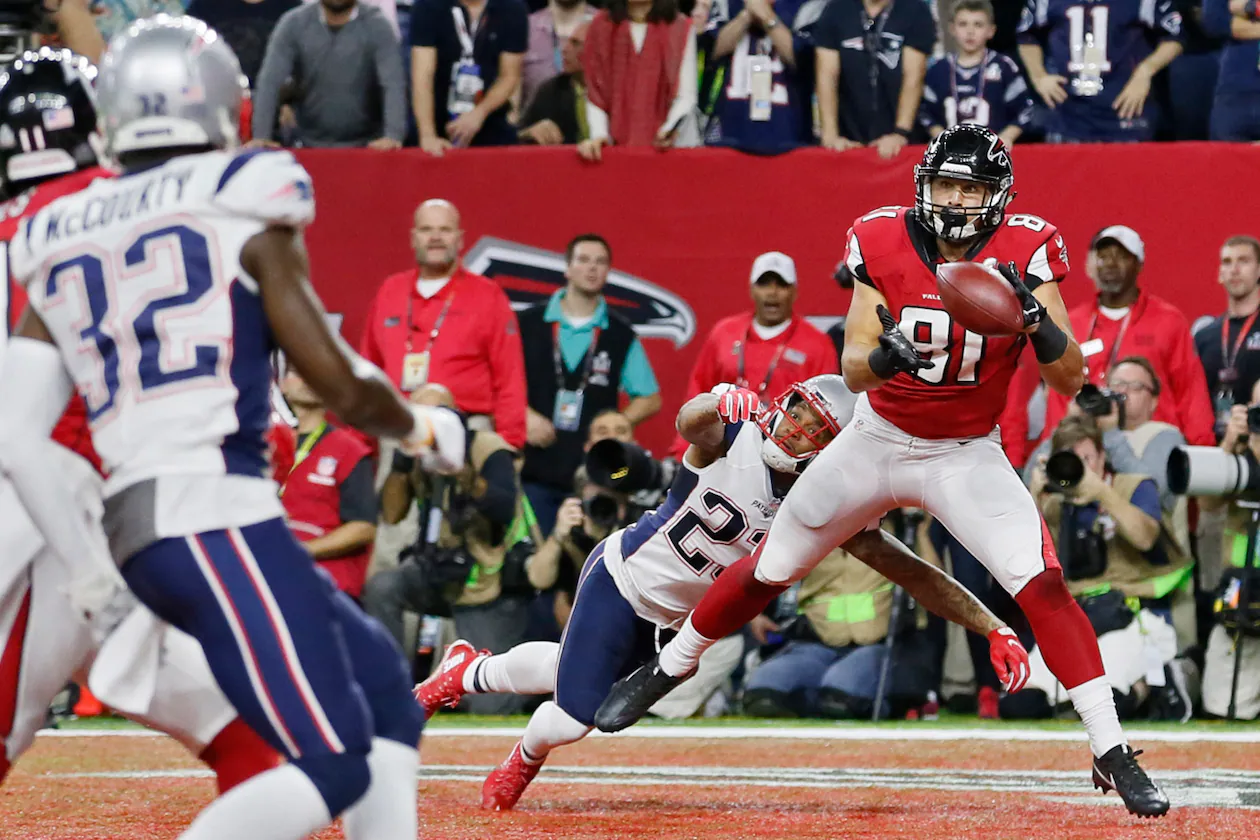 Austin Hooper (right) — pictured catching a touchdown for the Falcons against the Patriots in the Super Bowl in 2017 — is one of three former Atlanta players now playing for New England, which takes on Seattle in Sunday's Super Bowl in Santa Clara, Calif. (Bob Andres/AJC 2017)