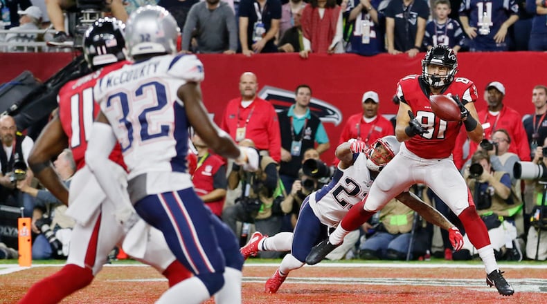 Austin Hooper (right) — pictured catching a touchdown for the Falcons against the Patriots in the Super Bowl in 2017 — is one of three former Atlanta players now playing for New England, which takes on Seattle in Sunday's Super Bowl in Santa Clara, Calif. (Bob Andres/AJC 2017)