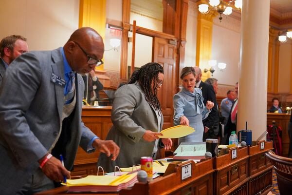 Georgia Senate Minority Leader Harold Jones, D-Augusta, Whip Kim Jackson, and Sen. Elena Parent sort through the nearly 20 floor amendments offered on HB127 during debate on the Senate floor, Wednesday, April 2, 2025, at the Georgia State Capitol in Atlanta. (Matthew Pearson/WABE via AP)