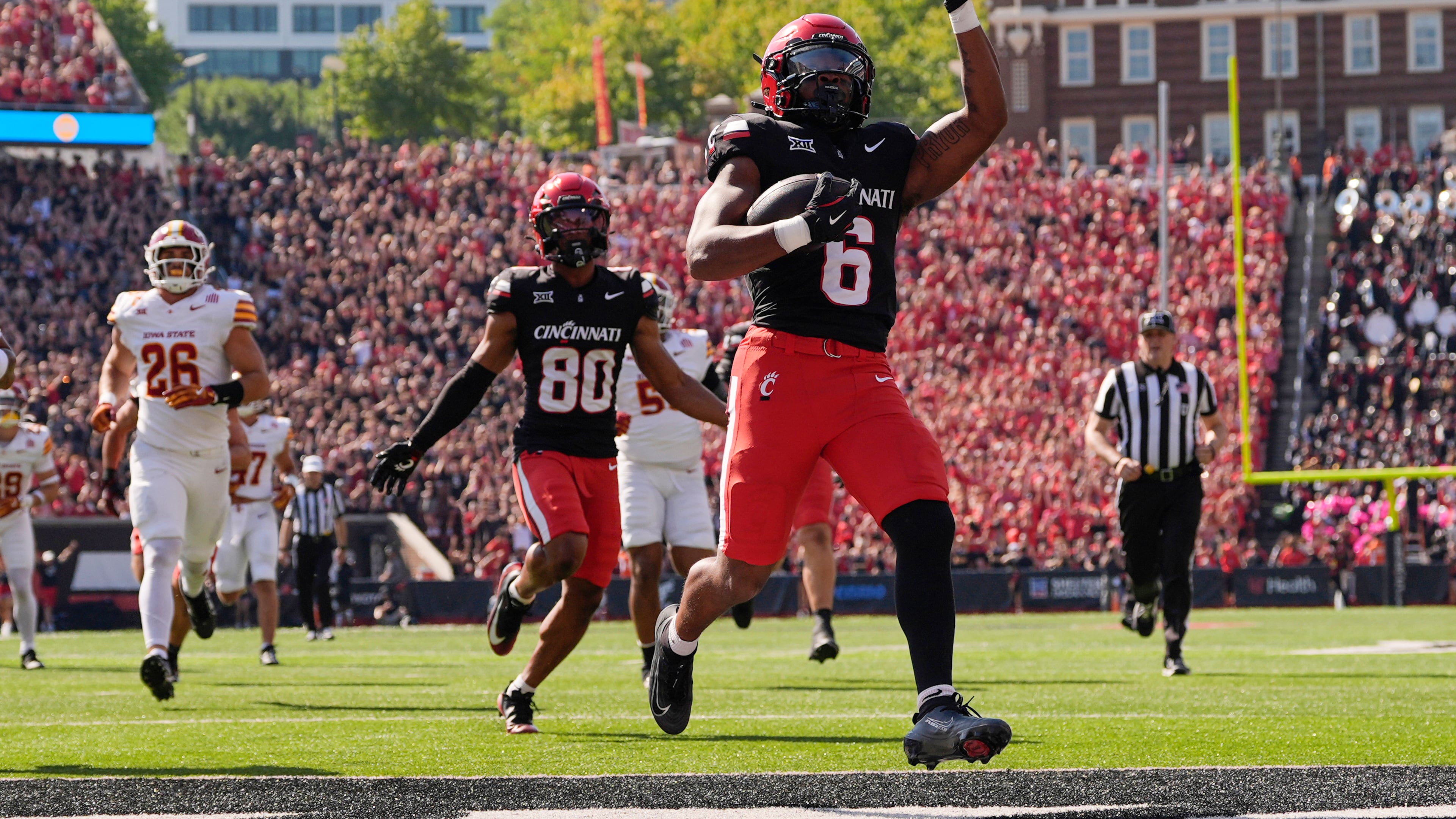 Cincinnati running back Evan Pryor (6) celebrates as he scores a touchdown against Iowa State during the first half of an NCAA football game, Saturday, Oct. 4, 2025, in Cincinnati. (AP Photo/Carolyn Kaster)