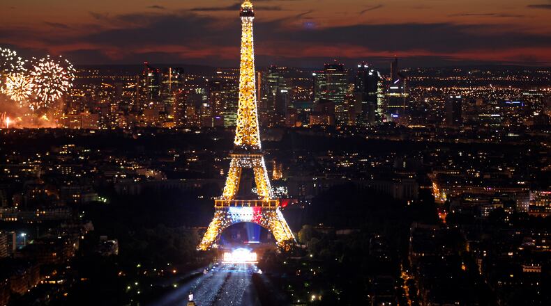 PARIS, FRANCE - JULY 14: The Eiffel Tower is shown lit up prior a fireworks show to celebrate Bastille Day on July 14, 2014 in Paris, France. Bastille Day commemorates the storming by Parisians of the Bastille fortress and prison on July 14, 1789 in Paris. (Photo by Thierry Chesnot/Getty Images)