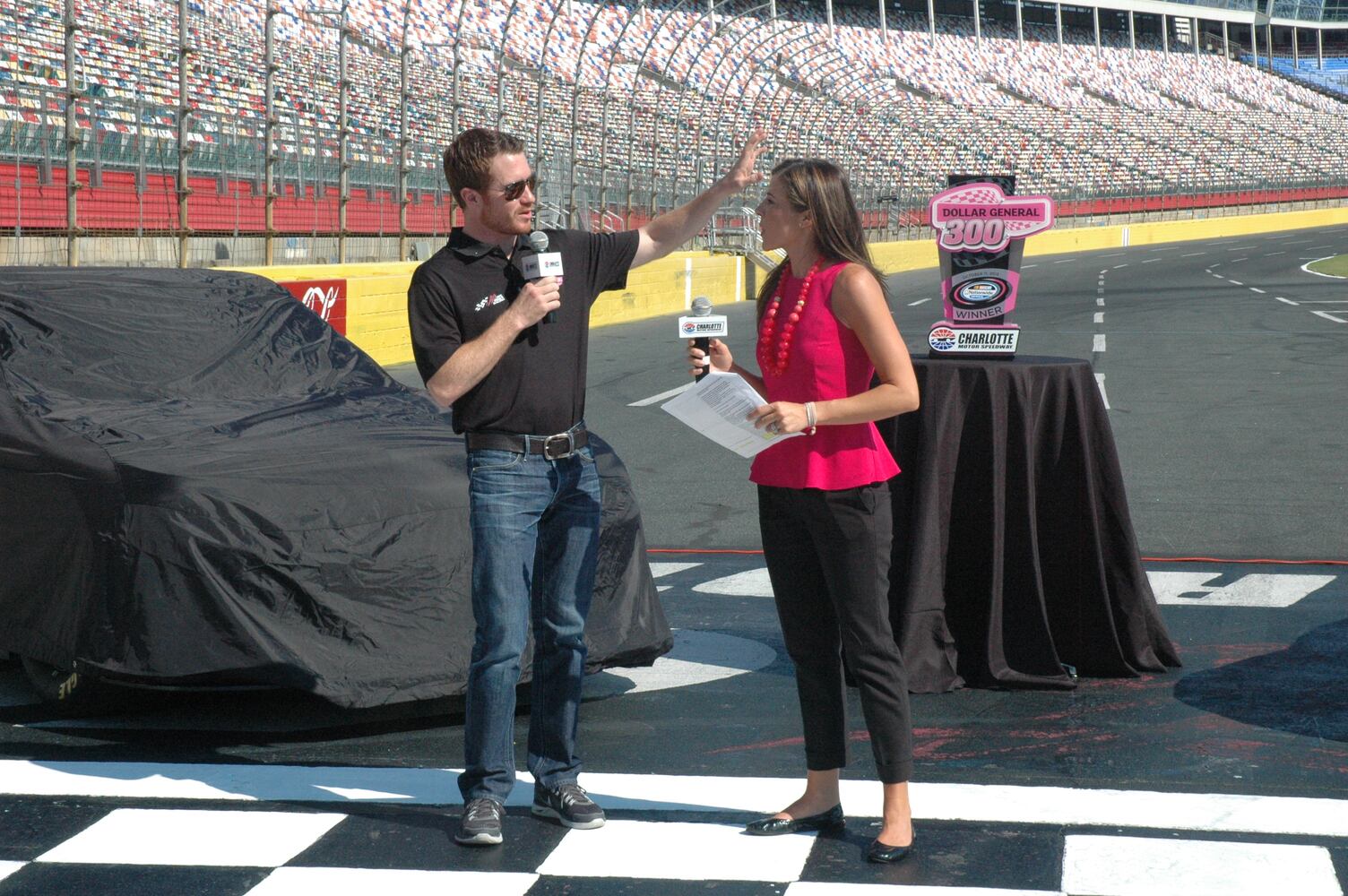 IMAGES: NASCAR drivers, breast cancer survivors paint pit road pink