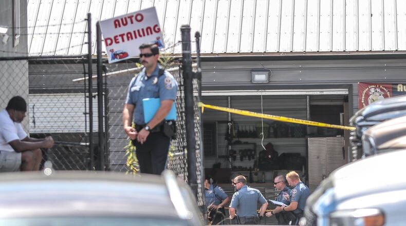 Gwinnett County police investigated a shooting at a Lilburn auto shop that officials say was the result of a dispute between a business owner and a man who died at the scene.