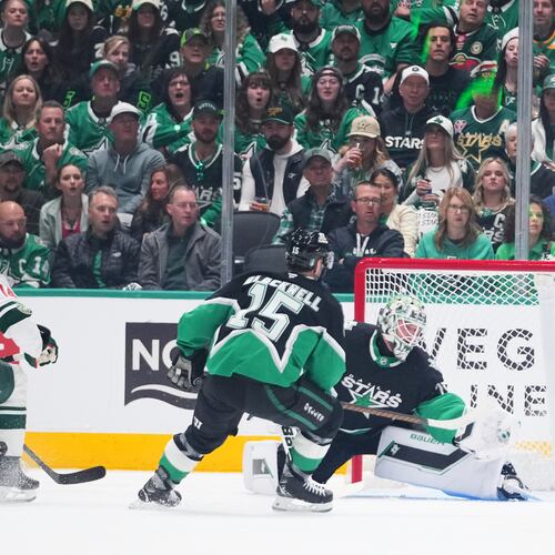 A shot by Minnesota Wild center Joel Eriksson Ek (14) enters the net of Dallas Stars goaltender Jake Oettinger, center, for a goal during the first period in Game 1 of a first-round NHL Stanley Cup playoffs hockey series, Saturday, April 18, 2026, in Dallas, Texas. (AP Photo/Julio Cortez)