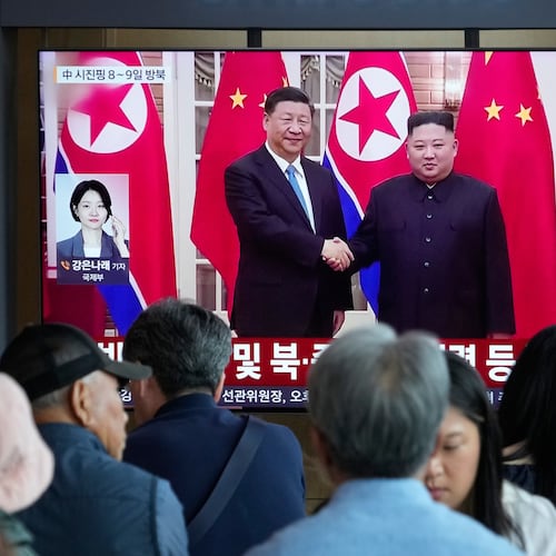 People watch a TV screen showing a file image of North Korean leader Kim Jong Un, right, and Chinese President Xi Jinping, at the Seoul Railway Station in Seoul, South Korea, Friday, June 5, 2026. (AP Photo/Ahn Young-joon)