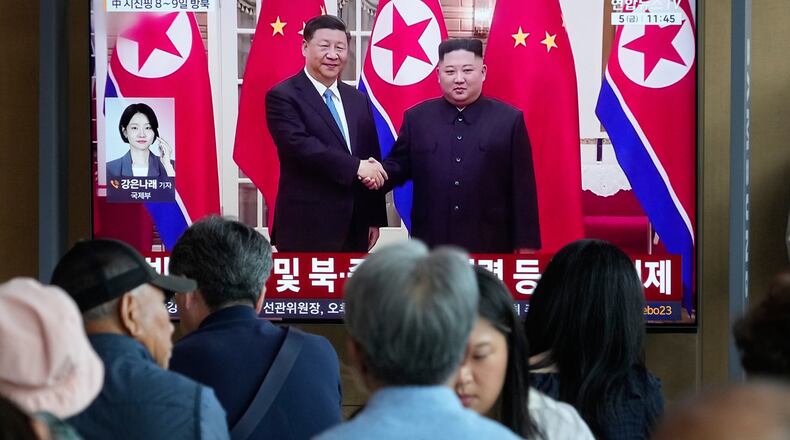 People watch a TV screen showing a file image of North Korean leader Kim Jong Un, right, and Chinese President Xi Jinping, at the Seoul Railway Station in Seoul, South Korea, Friday, June 5, 2026. (AP Photo/Ahn Young-joon)