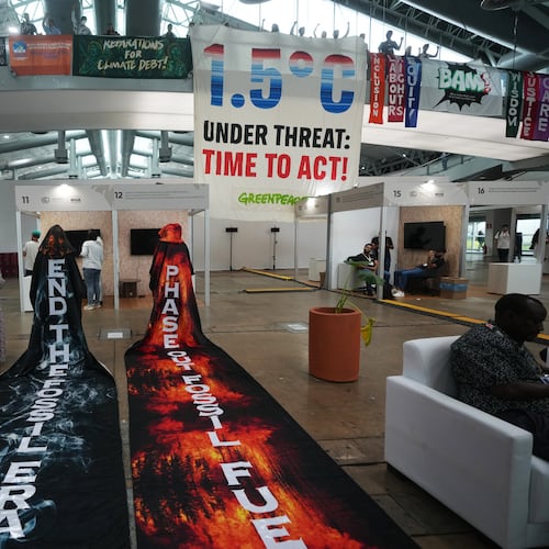 Activists hang banners while participating in a demonstration at the COP30 U.N. Climate Summit, Friday, Nov. 21, 2025, in Belem, Brazil. (AP Photo/Andre Penner)