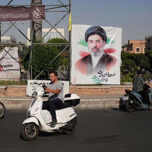 Motorbikes drive past a banner showing a portrait of the Iranian Supreme Leader Ayatollah Mojtaba Khamenei in downtown Tehran, Iran, Monday, June 29, 2026. (AP Photo/Vahid Salemi)