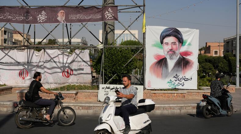 Motorbikes drive past a banner showing a portrait of the Iranian Supreme Leader Ayatollah Mojtaba Khamenei in downtown Tehran, Iran, Monday, June 29, 2026. (AP Photo/Vahid Salemi)