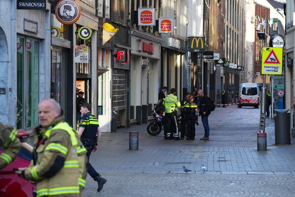 Emergency services personnel gather near the scene after a stabbing near Dam Square in central Amsterdam, Thursday, March 27, 2025. (AP Photo/Peter Delong)