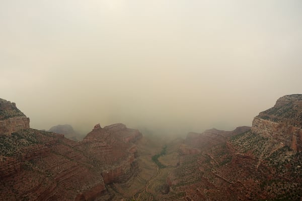 Smoke from the Dragon Bravo Fire moves over the Grand Canyon from the North Rim, Monday, July 14, 2025, in Grand Canyon National Park, Ariz. (AP Photo/Ross D. Franklin)
