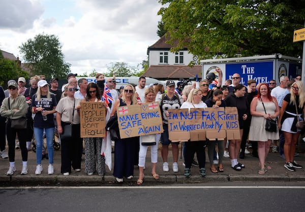 Protesters demonstrate outside the Bell Hotel in the town of Epping, Essex, England, Sunday, July 20, 2025. (Yui Mok/PA via AP)