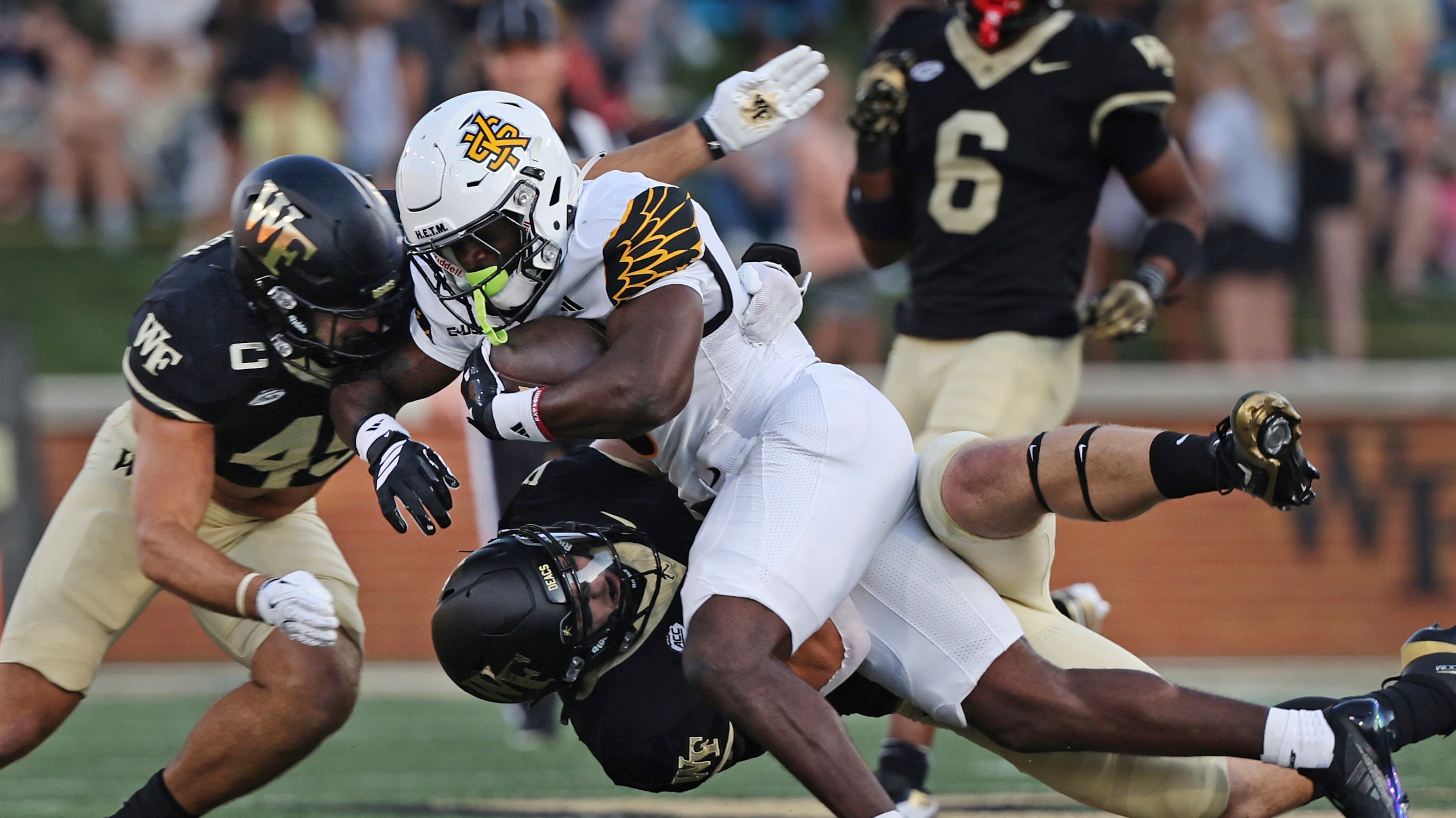 Wake Forest defensive back Nick Andersen (left) and linebacker Dylan Hazen take down Kennesaw State running back Coleman Bennett in the first half of an NCAA football game on Friday, Aug. 29, 2025 at in Winston-Salem, N.C. (Walt Unks/The Winston-Salem Journal via AP)
