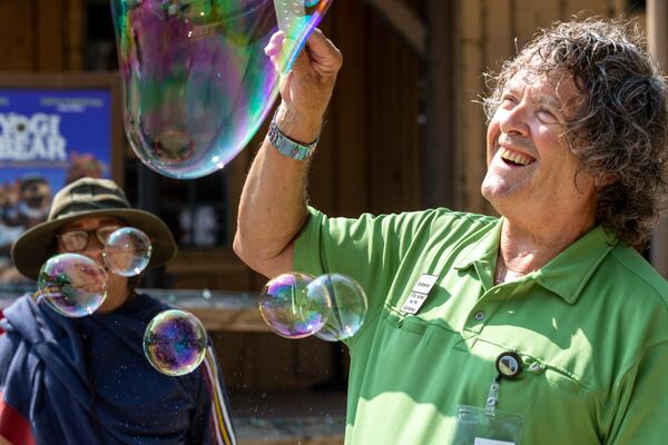 Robin Booth's love of bubbles started when he was gifted a bubble wand at the Yellow Daisy Festival decades ago. (Arvin Temkar / arvin.temkar@ajc.com)