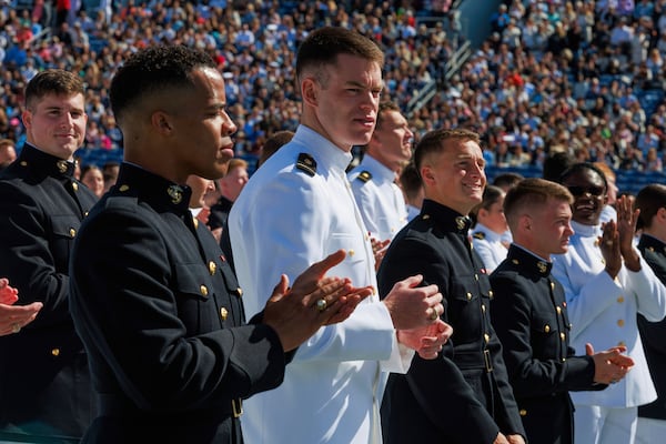 U.S. Naval Academy graduates applaud during the academy's graduation and commissioning ceremony at the U.S. Naval Academy in Annapolis, Md., Friday, May 23, 2025. (AP Photo/KT Kanazawich)