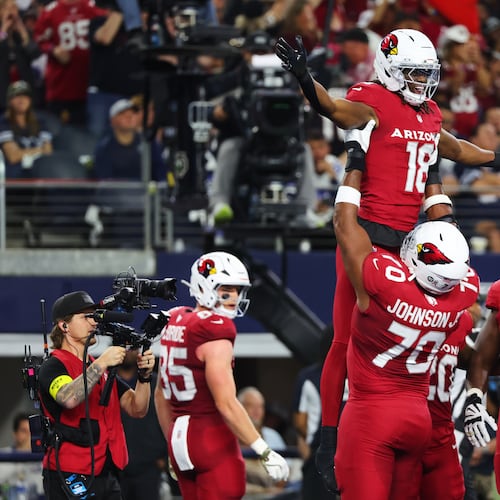 Arizona Cardinals wide receiver Marvin Harrison Jr. (18) is lifted by Paris Johnson Jr. (70) as the two and others celebrate Harrison Jr.s' touchdown catch in the first half of an NFL football game against the Dallas Cowboys Monday, Nov. 3, 2025, in Arlington, Texas. (AP Photo/Richard Rodriguez)