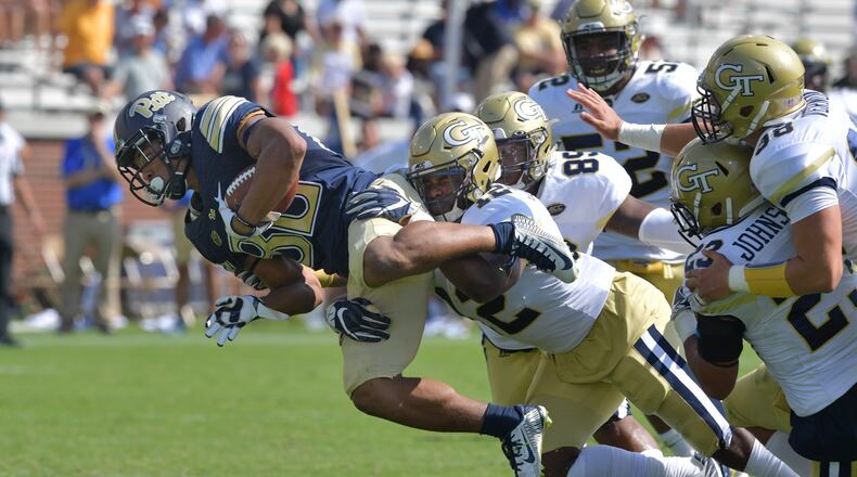 Pittsburgh tight end Chris Clark (87) is stopped by Georgia Tech linebacker Bruce Jordan-Swilling (12) in the second half of an NCAA college football game at Bobby Dodd Stadium on Saturday, September 23, 2017. Georgia Tech won 35 - 17 over the Pittsburgh. HYOSUB SHIN / HSHIN@AJC.COM