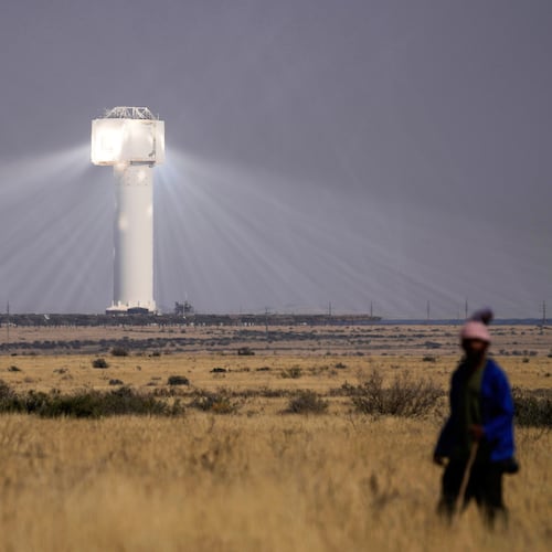 FILE - A shepherd watches livestock near Khi Solar One, a solar thermal plant that converts the sun's light energy into electricity, outside Upington, South Africa, in the Northern Cape province, Aug. 29, 2025. (AP Photo/Themba Hadebe, File)