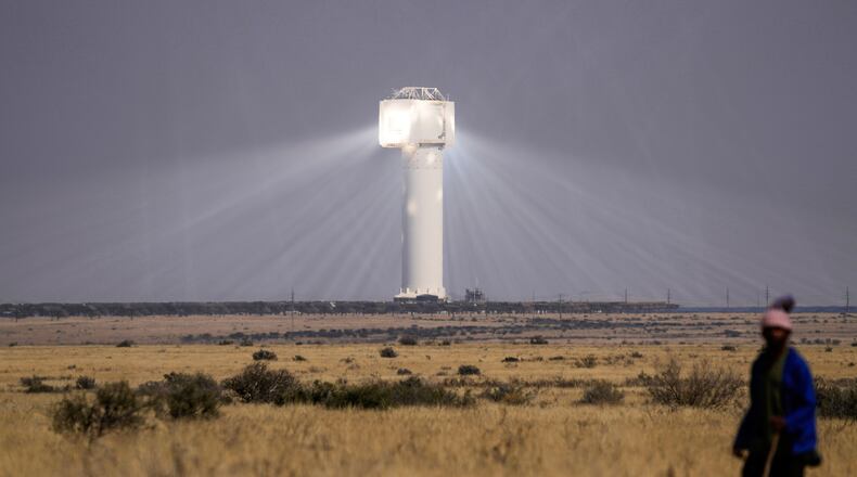 FILE - A shepherd watches livestock near Khi Solar One, a solar thermal plant that converts the sun's light energy into electricity, outside Upington, South Africa, in the Northern Cape province, Aug. 29, 2025. (AP Photo/Themba Hadebe, File)