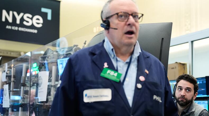 People work on the floor at the New York Stock Exchange in New York, Monday, April 13, 2026. (AP Photo/Seth Wenig)