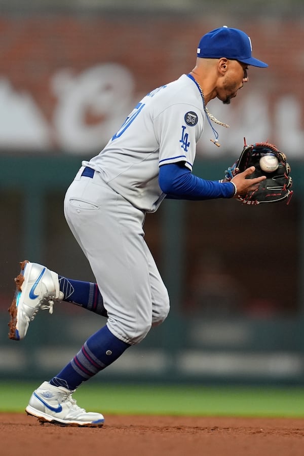 Los Angeles Dodgers shortstop Mookie Betts (50) fields a ball hit by Atlanta Braves' Nick Allen in the fourth inning of a baseball game, Sunday, May 4, 2025, in Atlanta. (AP Photo/Mike Stewart)