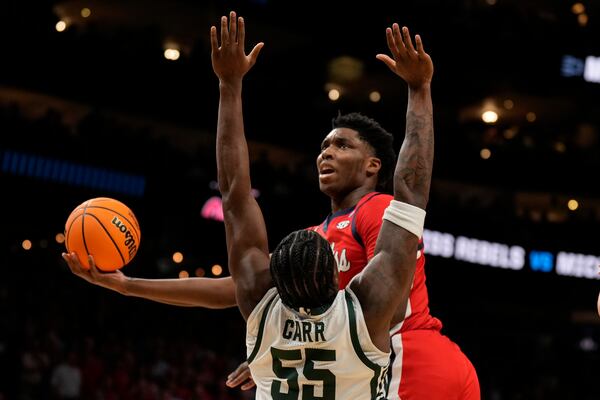 Mississippi forward Malik Dia (0) shoots against Michigan State forward Coen Carr (55) during the first half in the Sweet 16 of the NCAA college basketball tournament, Friday, March 28, 2025, in Atlanta. (AP Photo/George Walker IV)