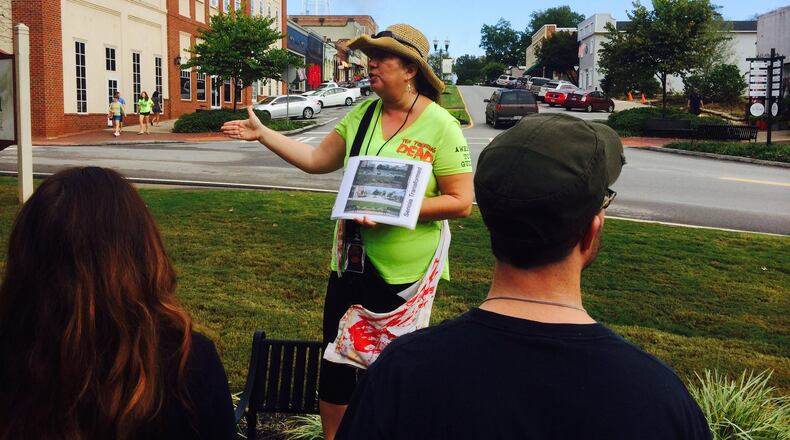 Tour guide Christina Tracy walks fans through the streets of Senoia, a primary location for the hit AMC TV series “The Walking Dead.” Photo credit: Jon Waterhouse