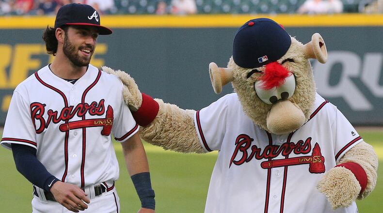 Atlanta Braves shortstop Dansby Swanson clowns around with team mascot, Blooper, while preparing to play the Philadelphia Phillies Tuesday, April 17, 2018, at SunTrust Park.