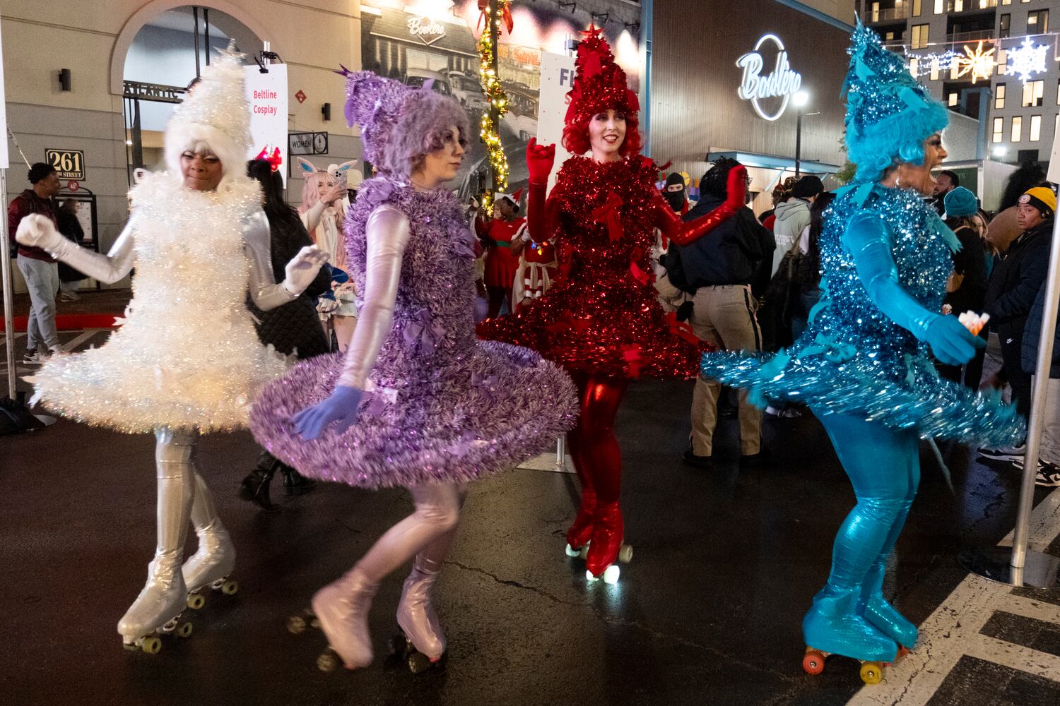 The Christmas Tree Skaters mess around before the start of the Christmas parade and tree lighting at Atlantic Station in Atlanta on Saturday, Nov. 23, 2024.   Ben Gray for the Atlanta Journal-Constitution
